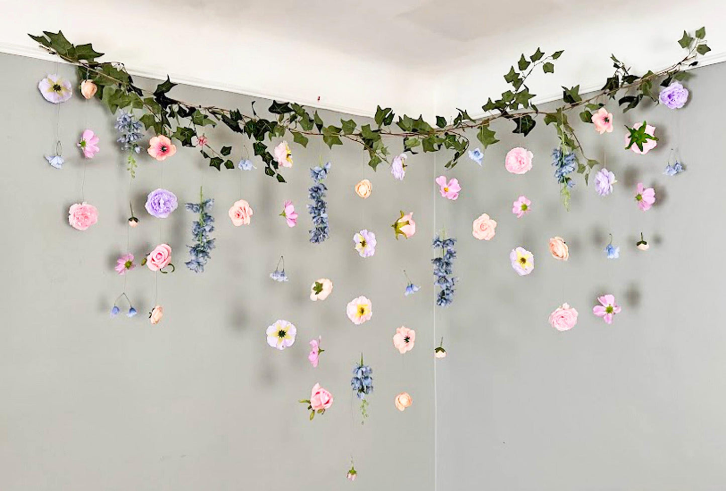 Decorative floral garland hanging on a plain wall
