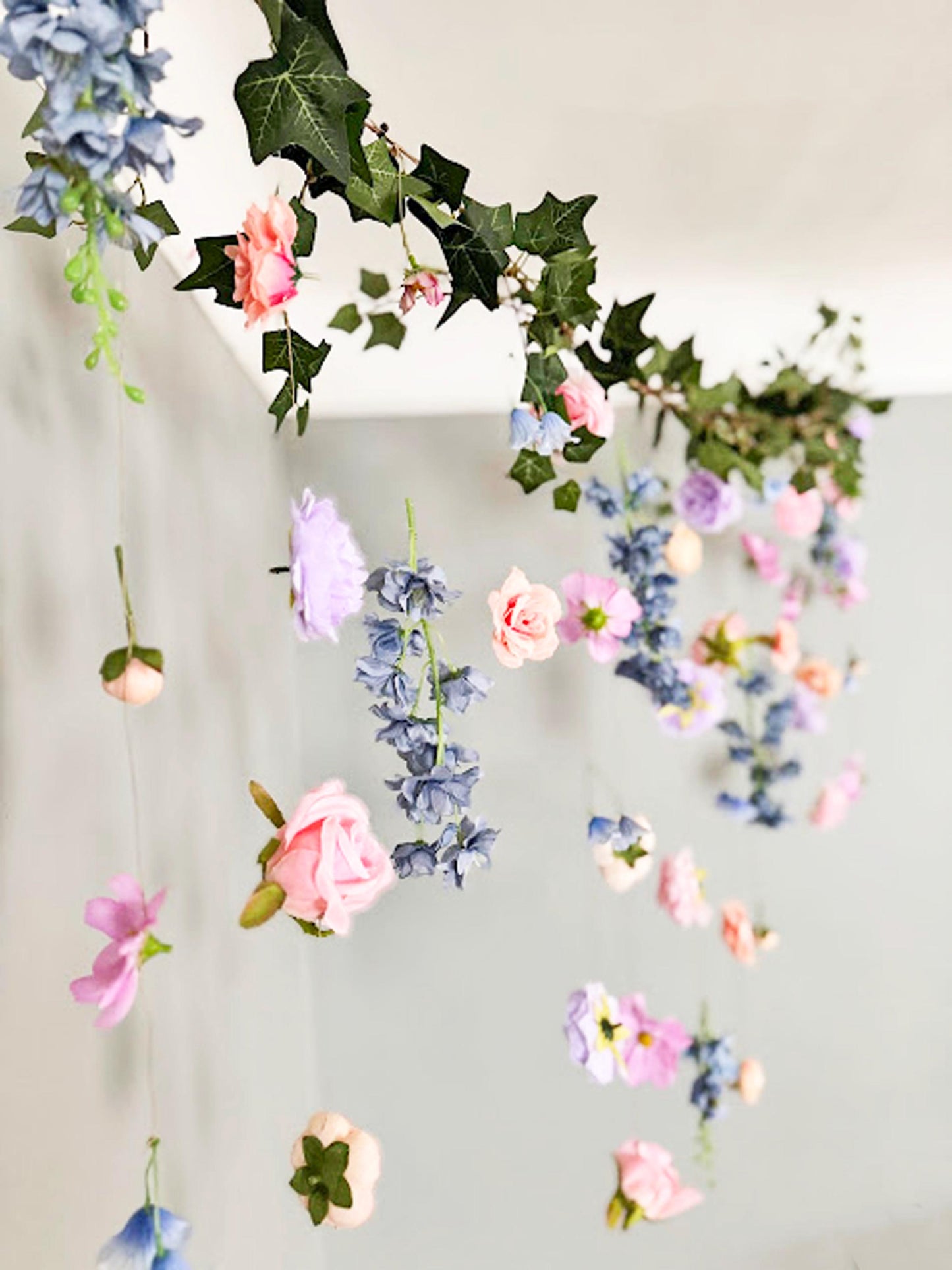 Decorative flowers and greenery garland on a white background