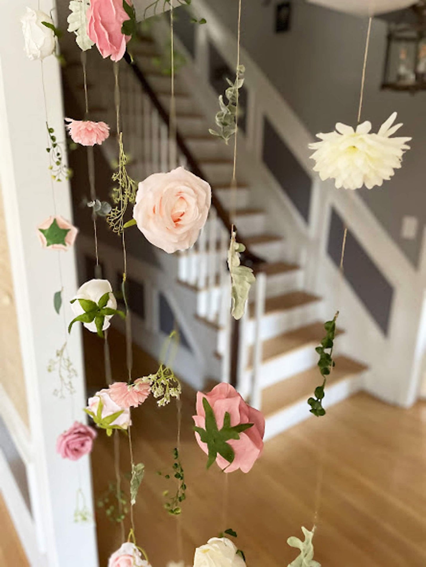 Decorative hanging flowers with pink, white, and green colors.