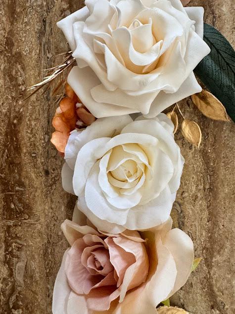 Close-up of white and pink roses on a textured surface